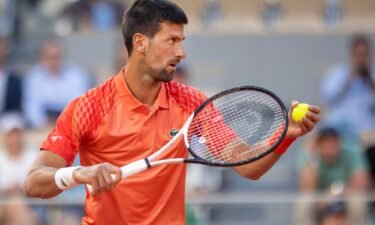 Novak Djokovic prepares to serve against Márton Fucsovics in the French Open second round.