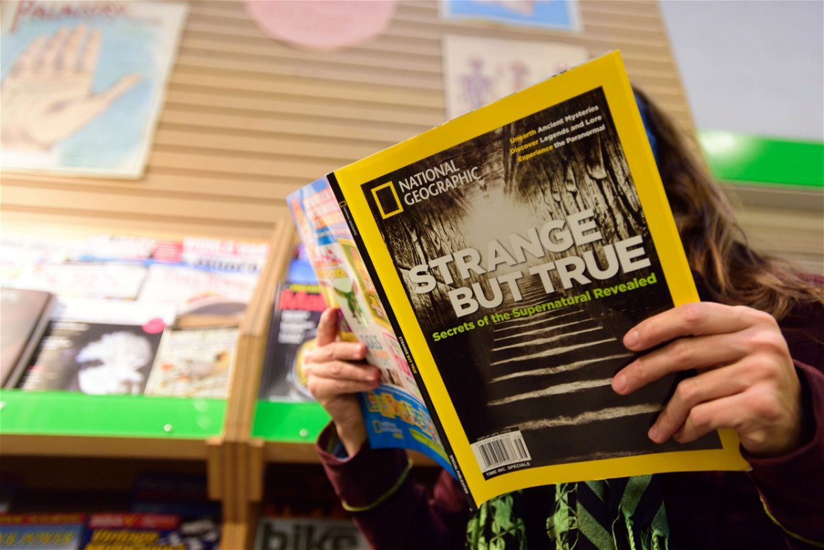 <i>Alex Milan Tracy/Sipa/AP</i><br/>A woman reads the current issue of National Geographic at Powell's City of Books in Portland