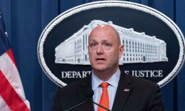 Patrick J. Lechleitner speaks during a news conference at the Department of Justice in Washington