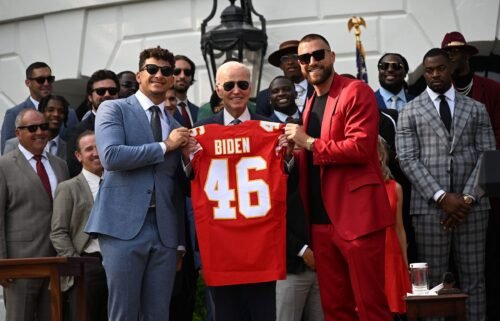 Kansas City Chiefs tight end Travis Kelce and quarterback Patrick Mahomes present President Joe Biden with a jersey during a celebration for the Kansas City Chiefs