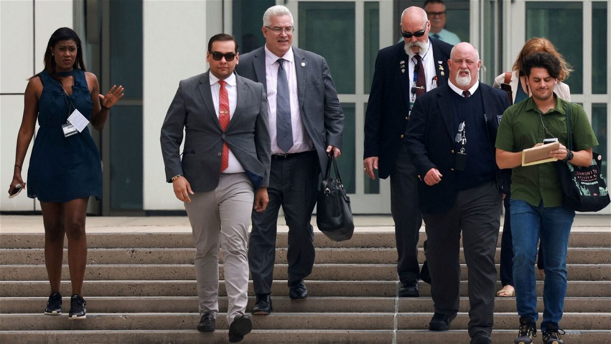 <i>Amr Alfiky/Reuters</i><br/>Rep. George Santos walks with his lawyer Joseph Murray outside the Central Islip Federal Courthouse on the day of his hearing