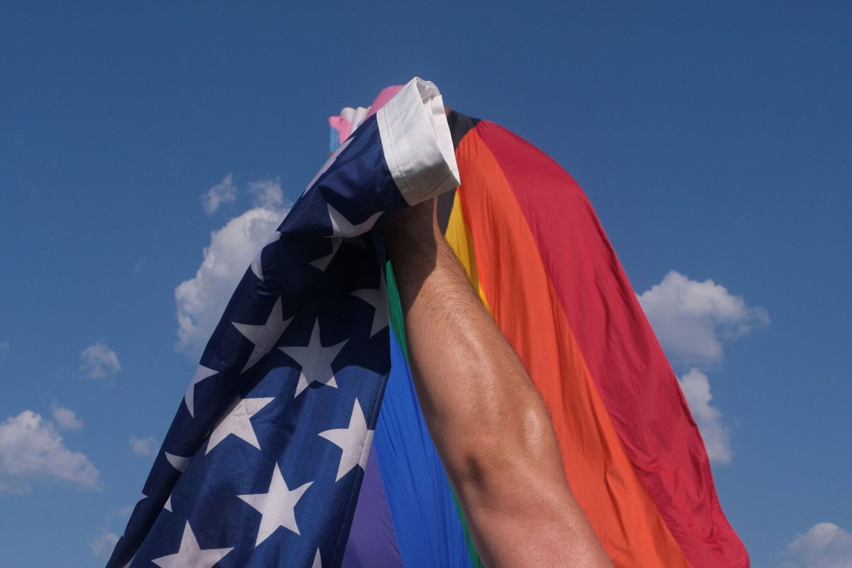 <i>Kevin Wurm/Reuters</i><br/>A vendor takes down a US flag while breaking down a booth after an all ages LGBTQ Pride event in Franklin