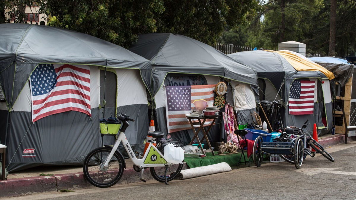 <i>George Rose/Getty Images</i><br/>Homeless veterans are housed in 30 tents on a sidewalk outside the Veteran's Administration campus on April 22