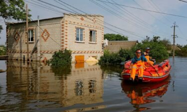 Members of Russia's emergencies ministry use an inflatable boat in a flooded area following the collapse of the Kakhovka dam on June 8.