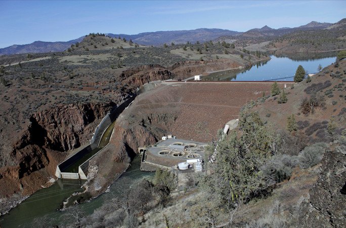 The Iron Gate Dam powerhouse and spillway are seen on the lower Klamath River near Hornbrook, Calif., on March 2, 2020. This dam, along with three others on the Klamath River, are scheduled to be removed by the end of 2024. Crews will work to restore the river and surrounding land