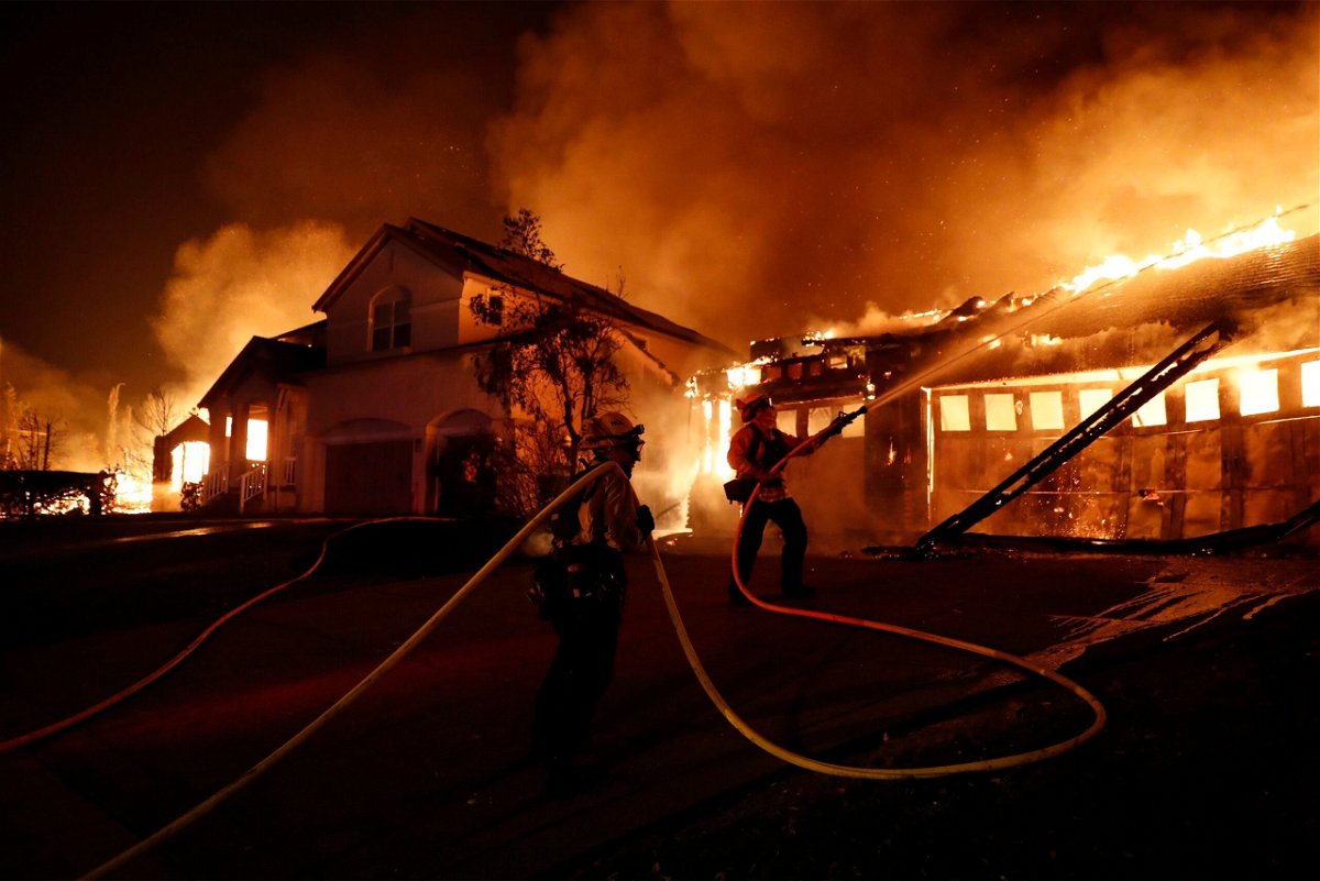 <i>Scott Strazzante/The San Francisco Chronicle/Getty Images</i><br/>Firefighters try to keep house fires from spreading on Mountain Hawk Drive as the Shady Fire burns in the Skyhawk area of Santa Rosa