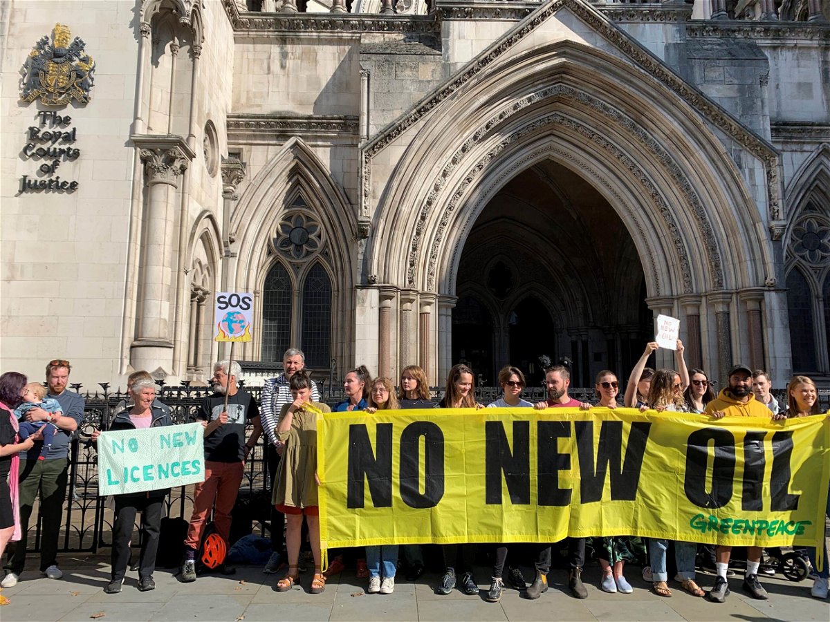 <i>Tom Pilgrim/PA Images/Getty Images</i><br/>Protestors gather outside the Royal Courts of Justice in London on July 25