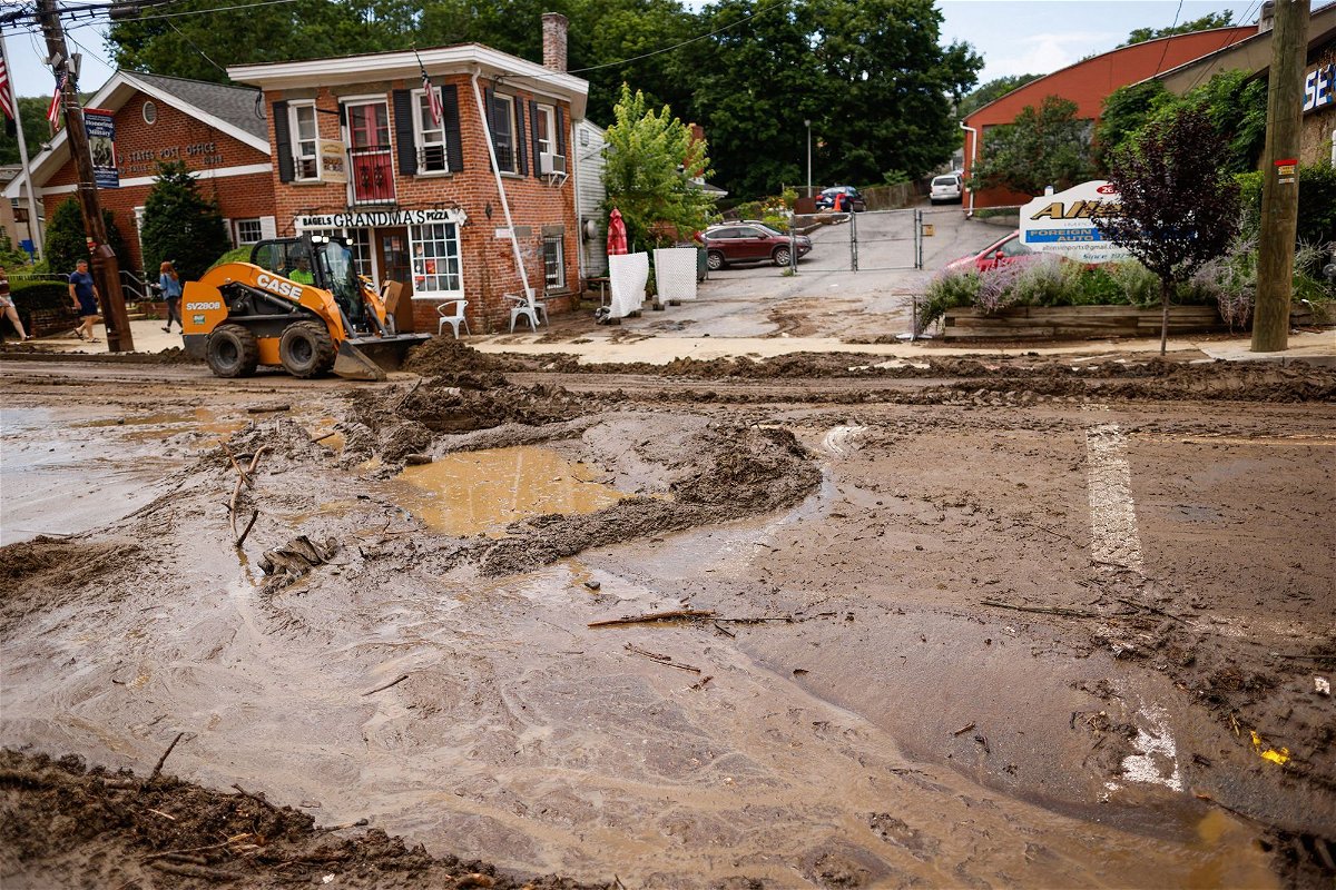 <i>Kena Betancur/AFP/Getty Images</i><br/>Workers remove mud from Main street after heavy rains in Highland Falls