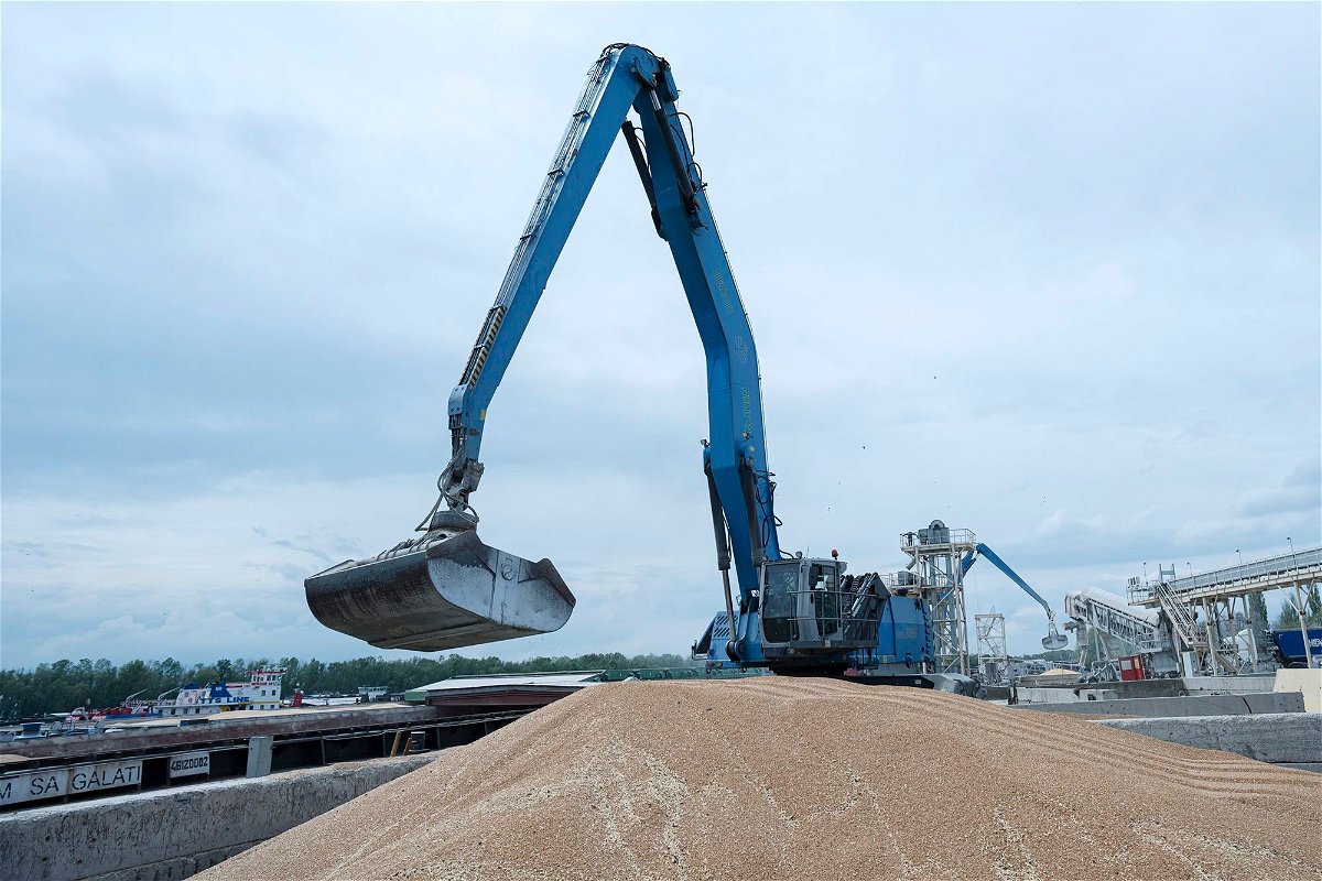 <i>Andrew Kravchenko/AP/FILE</i><br/>An excavator loads grain into a cargo ship at a grain port in Izmail