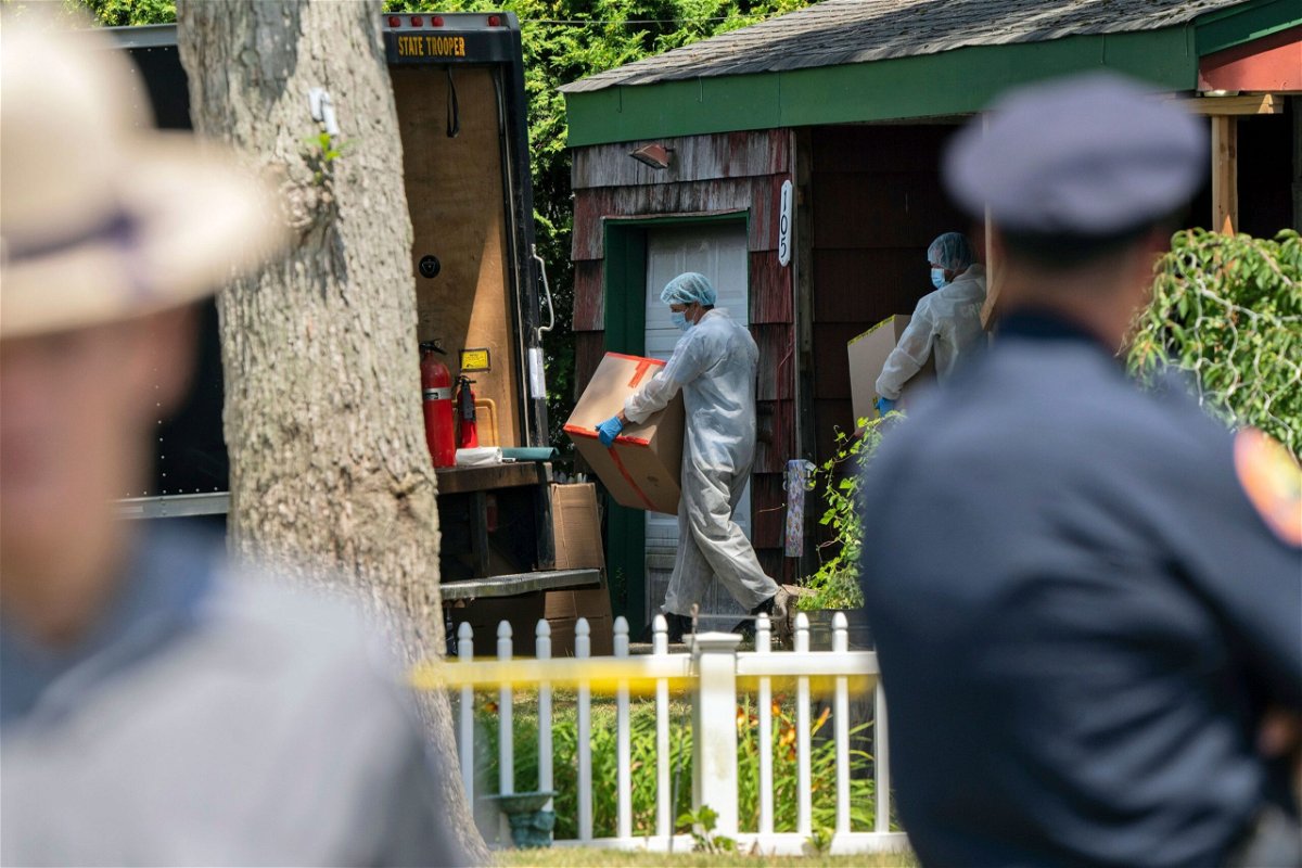 <i>Jeenah Moom/AP</i><br/>Crime laboratory officers remove boxes as law enforcement searches the home of Rex Heuermann