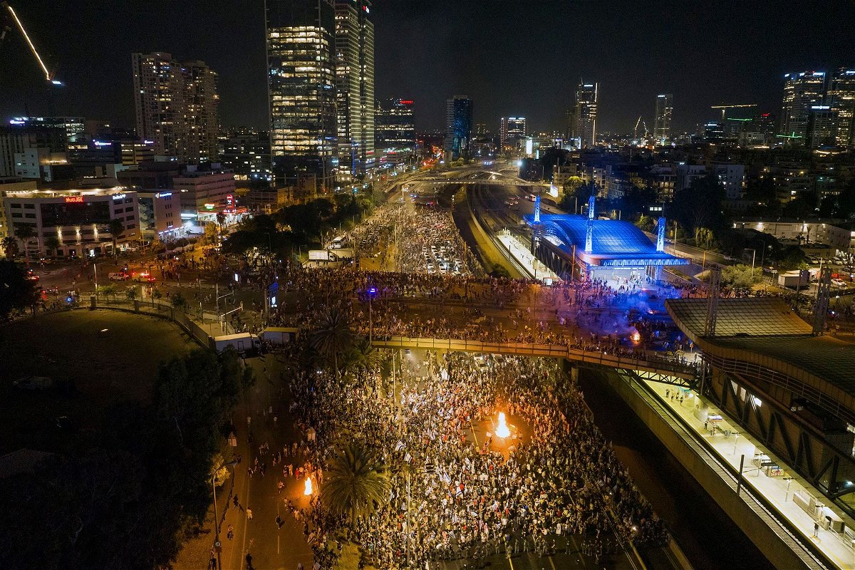 <i>Oded Balilty/AP</i><br/>Demonstrators block the traffic on a highway crossing the city during a protest against plans by Netanyahu's government to overhaul the judicial system