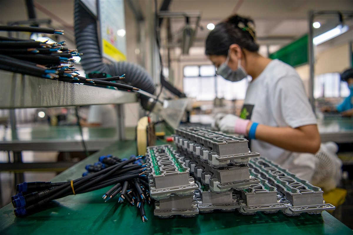 <i>Hu Xiaofei/VCG/Getty Images</i><br/>An employee works on the assembly line of LED lighting products at Pujiang Sansi Optoelectronics Technology Co.