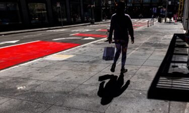 A pedestrian carries a shopping bag in San Francisco