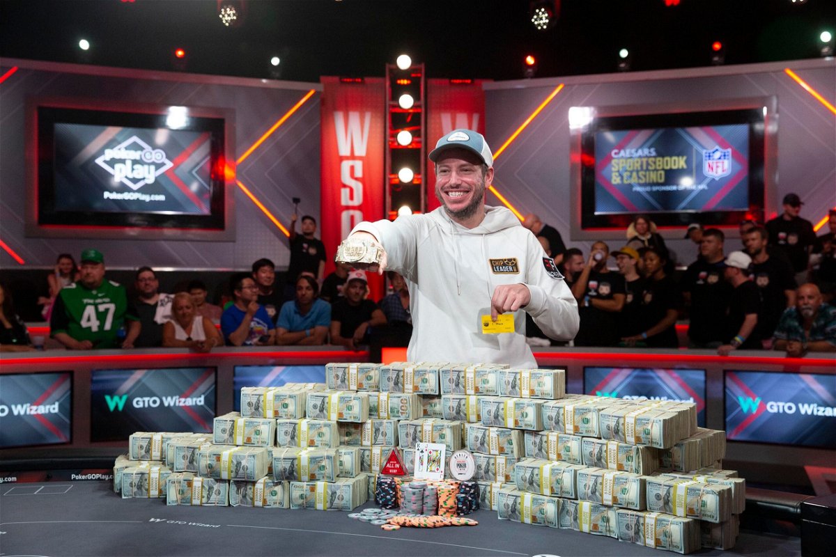 <i>Steve Marcus/Las Vegas Sun/AP</i><br/>Daniel Weinman displays his championship bracelet and bundles of cash after winning the World Series of Poker Main Event.