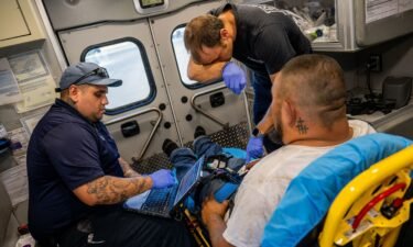 Emergency Medical Technicians William Dorsey and Omar Amezcua assist a person after he called in for chest pain on June 29