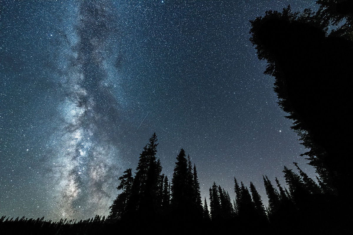 <i>Diana Robinson Photography/Moment RF/Getty Images</i><br/>The Delta Aquariids meteor shower and the Milky Way can be seen over the Gifford Pinchot National Forest near Mount Adams in Washington state.