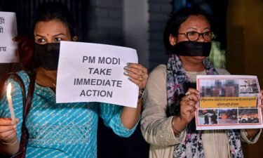 Protesters hold placards during a demonstration over sexual violence against women in Manipur
