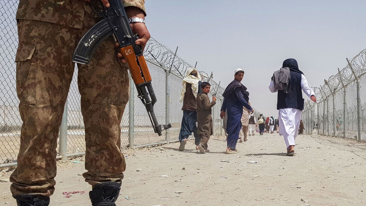 <i>AFP via Getty Images/FILE</i><br/>A Pakistani soldier stands guard as stranded Afghan nationals return to Afghanistan at the Pakistan-Afghanistan border crossing point in Chaman on August 15