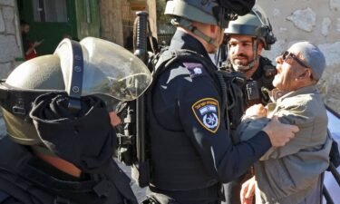 Israeli security forces scuffle with a Palestinian man as he tries to enter the al-Aqsa mosque compound to attend  Friday prayers on April 15
