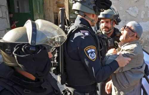 Israeli security forces scuffle with a Palestinian man as he tries to enter the al-Aqsa mosque compound to attend  Friday prayers on April 15