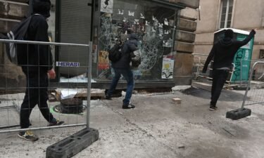 Protesters smash a shop window during unrest in Nantes in western France on June 30.