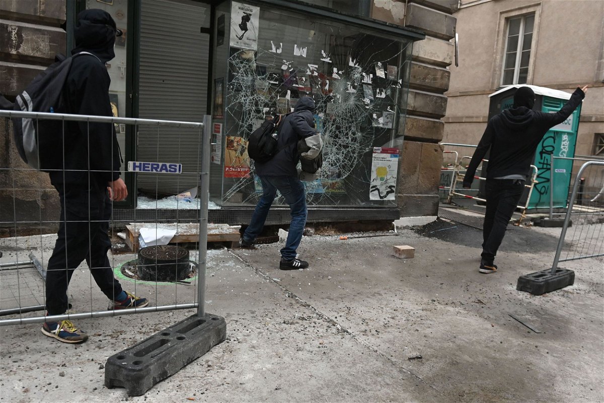 <i>Sebastien Salom-Gomis/AFP/Getty Images</i><br/>Protesters smash a shop window during unrest in Nantes in western France on June 30.