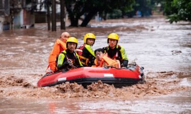 Rescue workers evacuate stranded residents after heavy rainfall in Chongqing