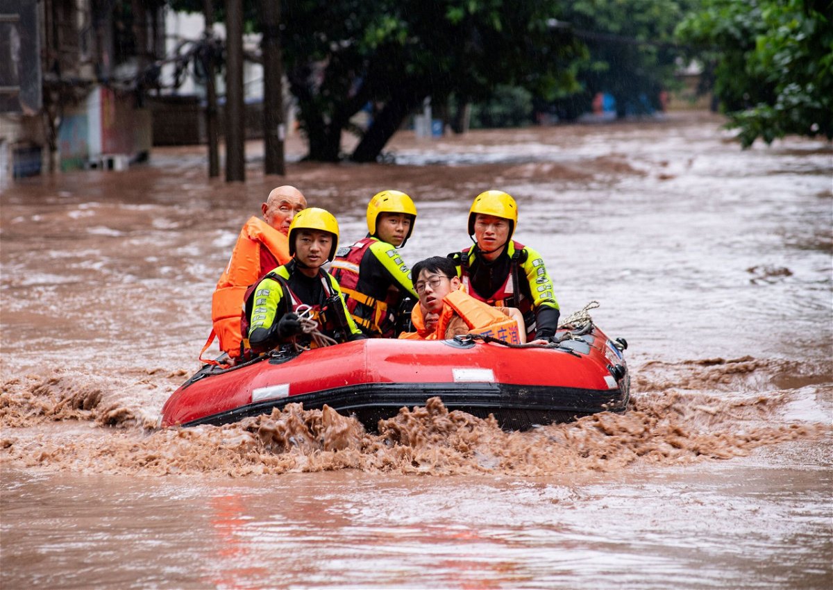 <i>Cnsphoto/Reuters</i><br/>Rescue workers evacuate stranded residents after heavy rainfall in Chongqing