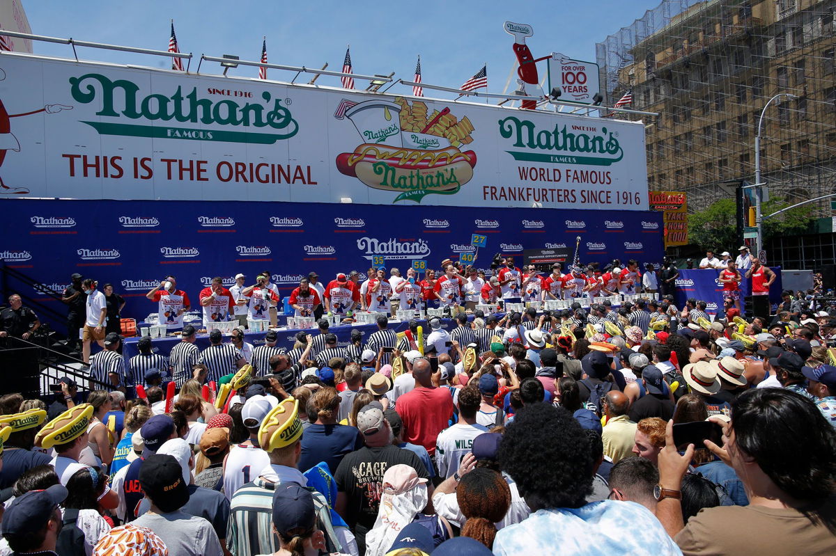 <i>Kena Betancur/Getty Images</i><br/>Competitors chow down during Nathan's Famous International Hot Dog Eating Contest on July 4