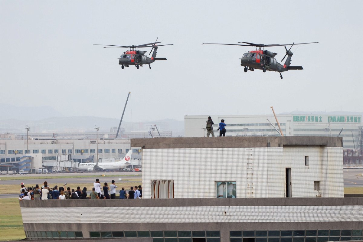 <i>Ann Wang/Reuters</i><br/>Black Hawk helicopters prepare to land at Taoyuan International Airport as part of the annual Han Kuang military exercise on July 26.