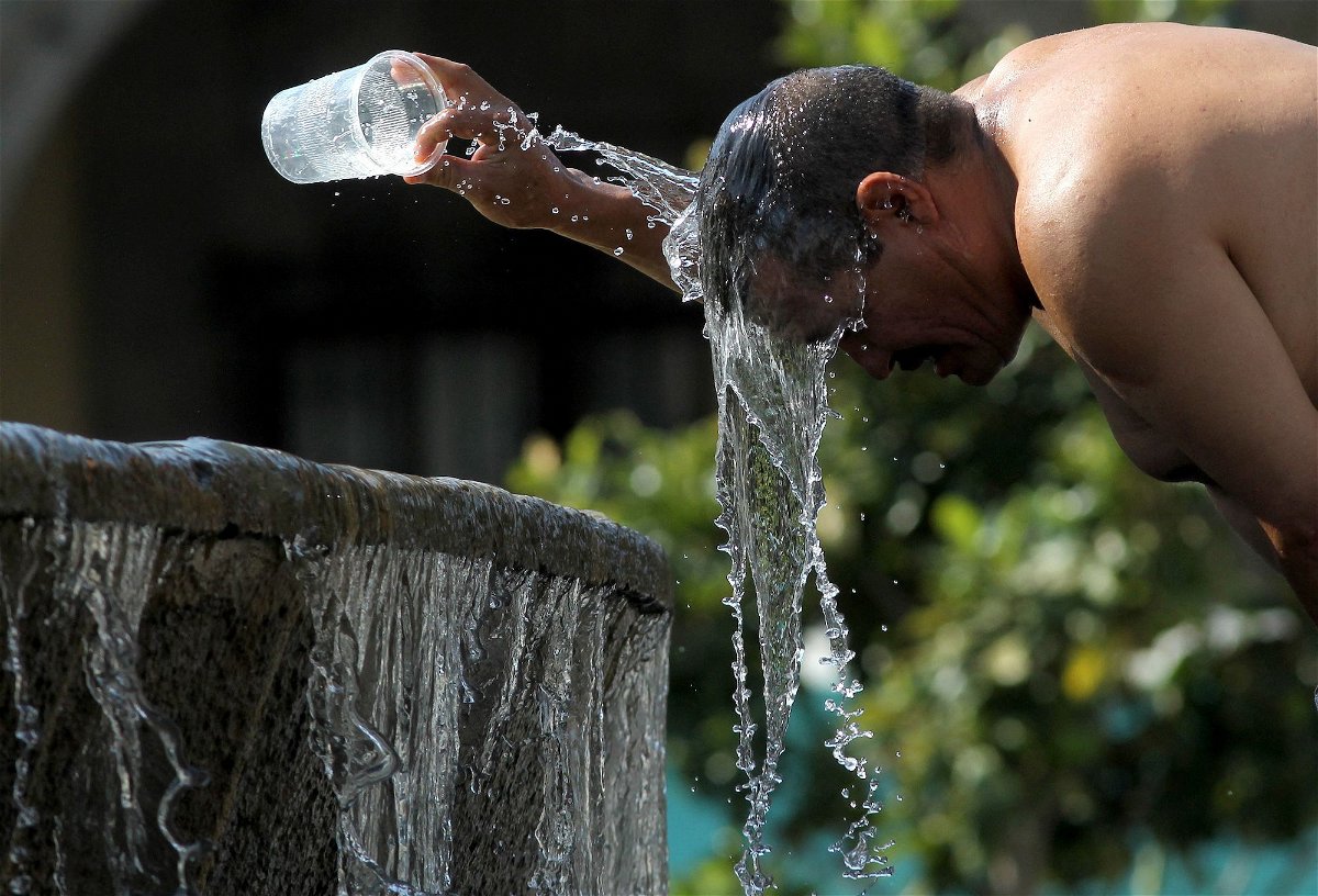 <i>Ulises Ruiz/AFP/Getty Images</i><br/>A man cools himself down with water from a water fountain during one of the hottest days of the third heat wave in Guadalajara