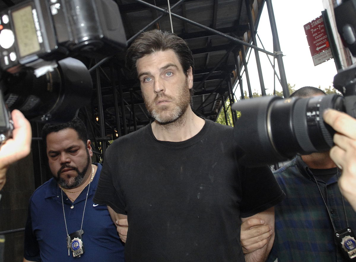 <i>Louis Lanzano/AP/FILE</i><br/>Robert Chambers is led in handcuffs into Manhattan criminal court in 2007 for his arraignment on charges of selling cocaine.