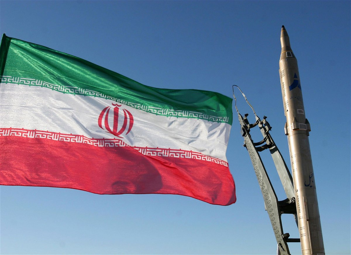 <i>AFP/Getty Images</i><br/>An Iranian flag flutters next to a ground-to-ground Sajil missile before being launched at an undisclosed location in Iran on November 12