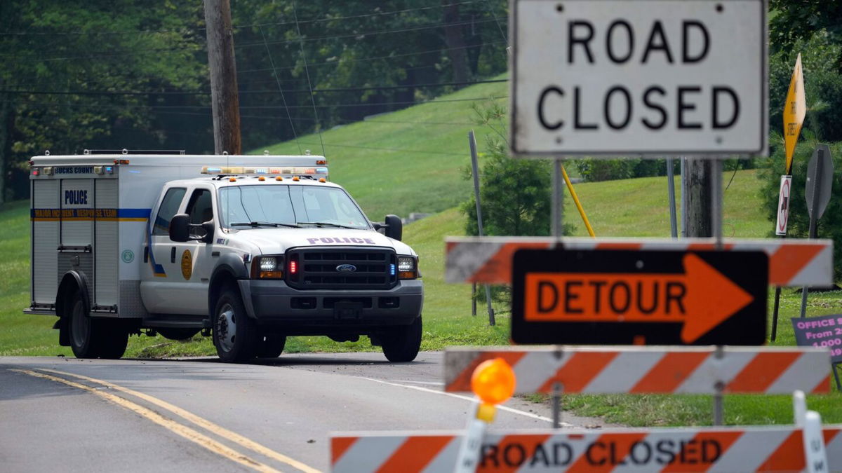 <i>Matt Slocum/AP</i><br/>A roadblock is seen as crews search for a a pair of missing children swept away after weekend rains