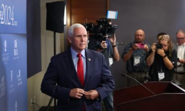 Republican presidential candidate Mike Pence speaks to the press after addressing guests at the Family Leadership Summit in Des Moines