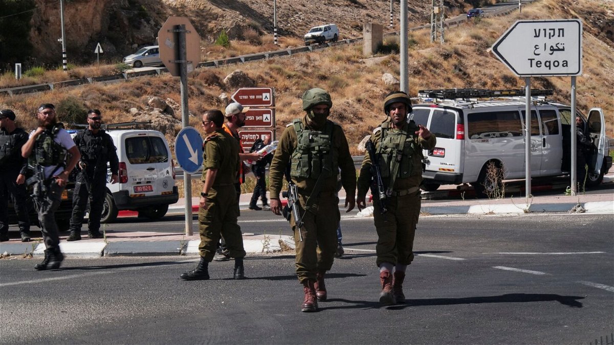 <i>Dedi Hayun/Reuters</i><br/>Israeli military and security personnel work at the scene of a shooting attack at Tekoa Junction in the Israeli-occupied West Bank on July 16.