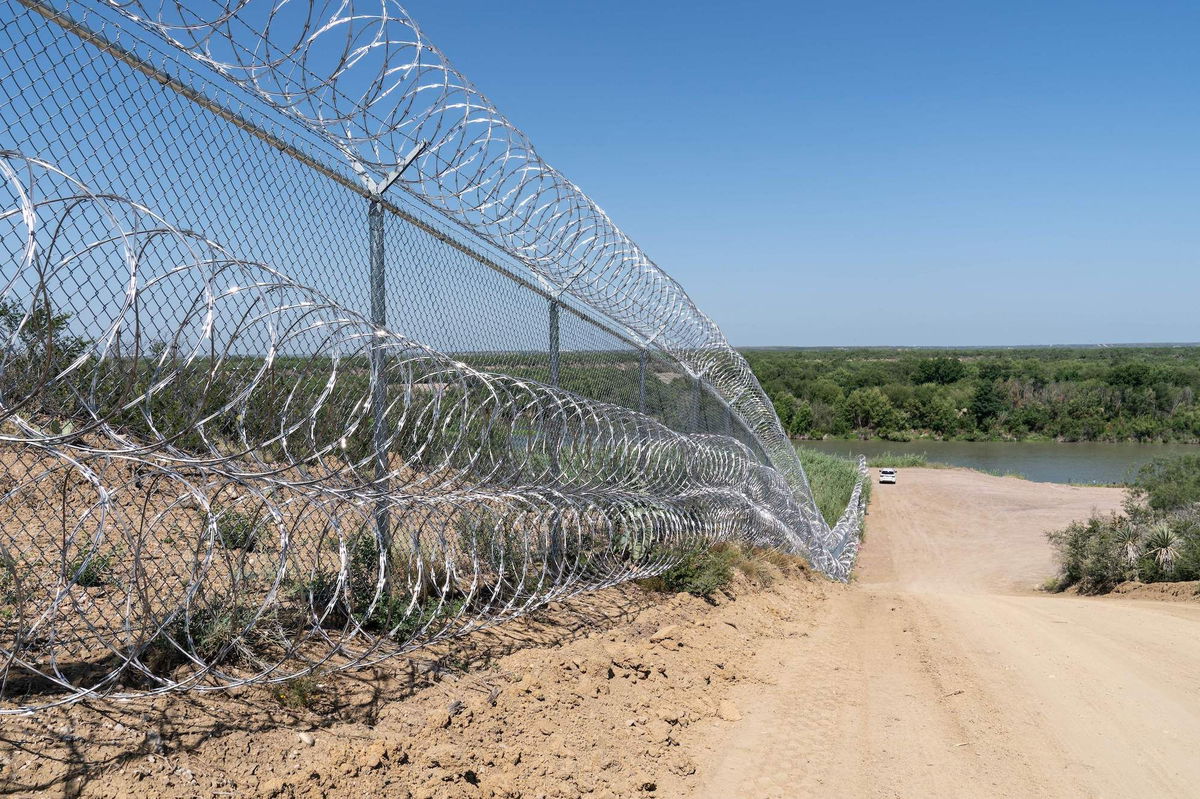 <i>Suzanne Cordeiro/AFP/Getty Images/FILE</i><br/>A razor wire fence runs alongside the Rio Grande River in Eagle Pass