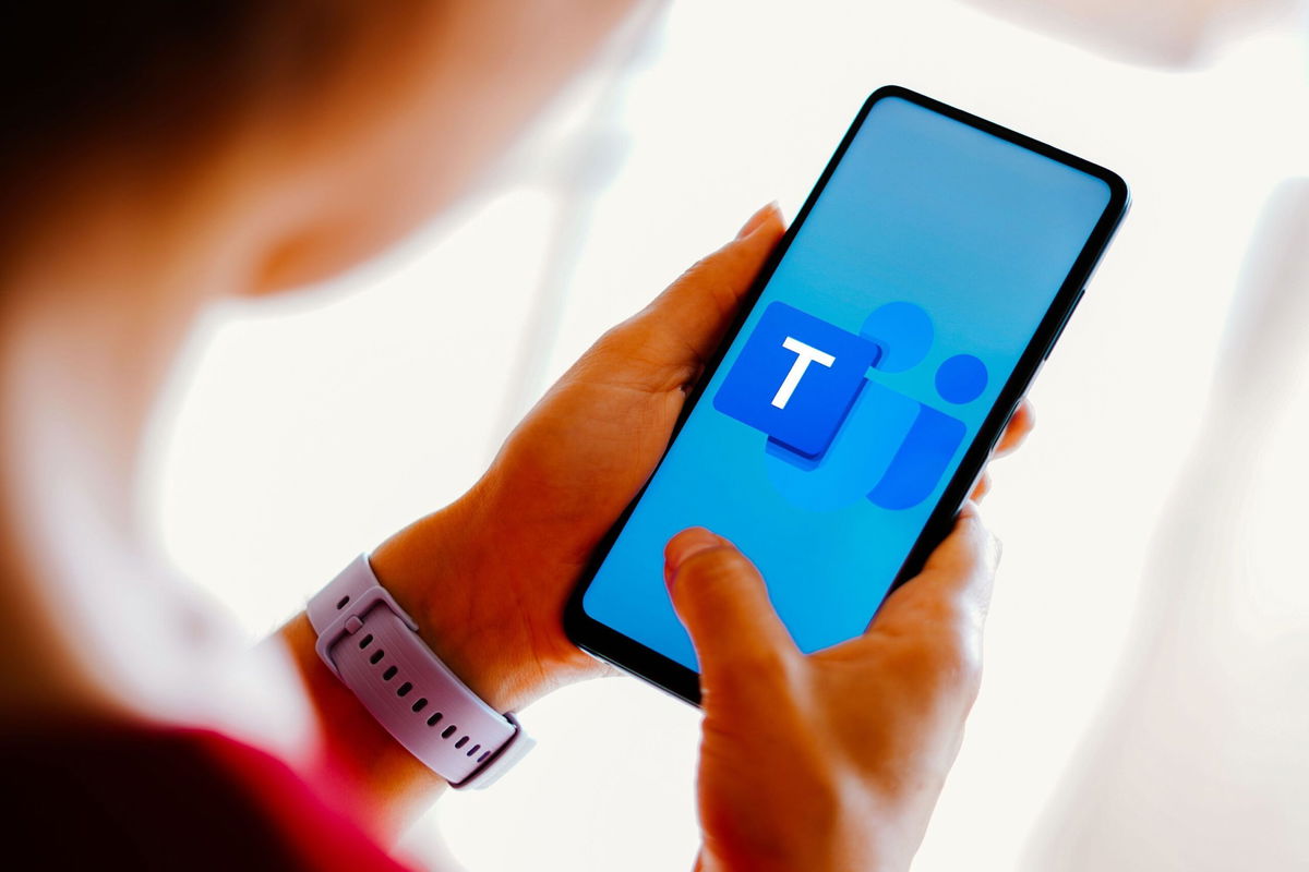 The Microsoft Teams logo is displayed on a smartphone screen.