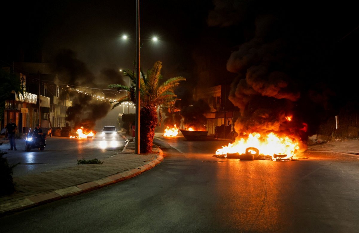 <i>Raneen Sawafta/Reuters</i><br/>Tires are set on fire on a street during an Israeli military operation