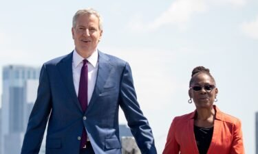 New York City Mayor Bill de Blasio (left) and his wife Chirlane McCray arrive for a dedication ceremony for the new Statue of Liberty Museum