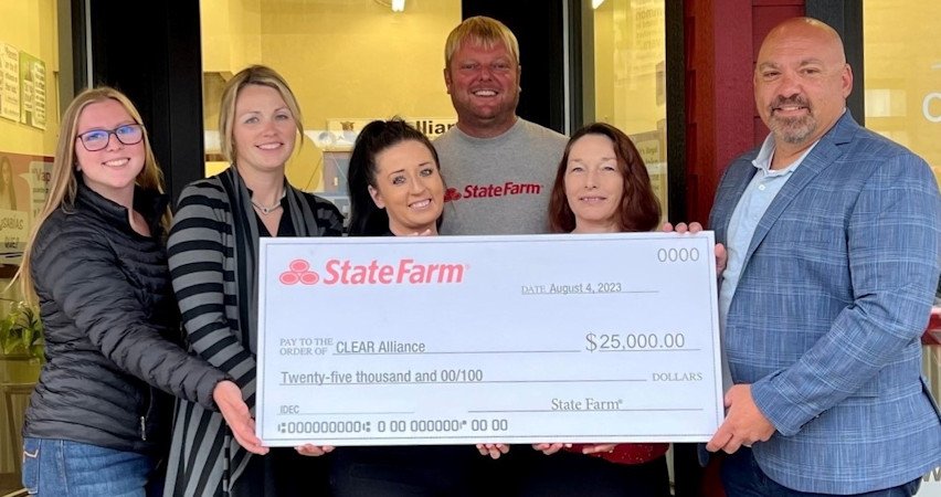 State Farm agent Mike Hornback (center) and his team presenting check to Sgt. Kent van der Kamp (right) from Deschutes Sheriff’s Office and Chairman of the Board for Clear Alliance