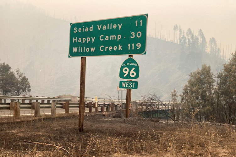 In this photo provided by Caltrans, smoke from the Head Fire blankets the closed State Route 96 in Klamath National Forest, Calif., on Wednesday, Aug. 16