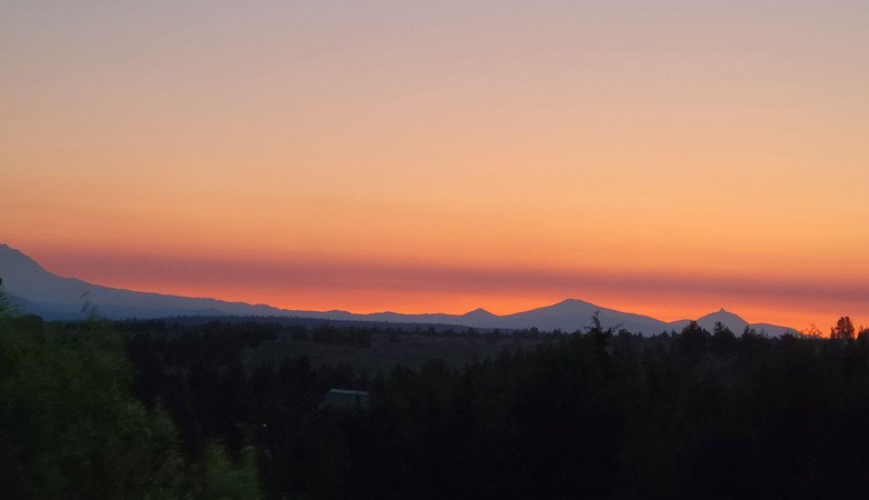 Wildfire smoke on the horizon in a view of the mountains