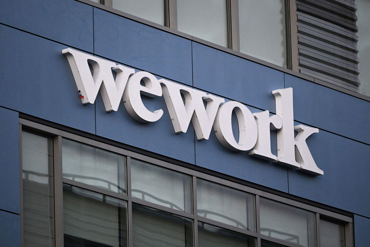 <i>Patrick T. Fallon/AFP/Getty Images</i><br/>The WeWork logo is displayed outside of a shared commercial office space building in Los Angeles
