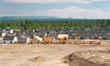 Aerial establishing shot of suburban homes being built over farmland in southeast Bend