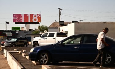 A billboard displays a temperature of 118 degrees Fahrenheit (48 degrees Celcius) during a record heat wave in Phoenix