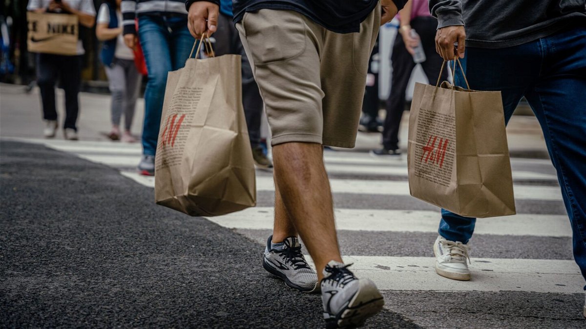 <i>Jamie Kelter Davis/Bloomberg via Getty Images</i><br/>Shoppers carry retail bags along the Magnificent Mile shopping district in Chicago on Aug. 15. US retail sales rose in July by more than forecast