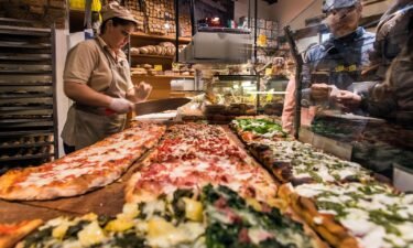 Different varieties of pizza served al taglio in a bakery of Rome's Trastevere neighborhood.