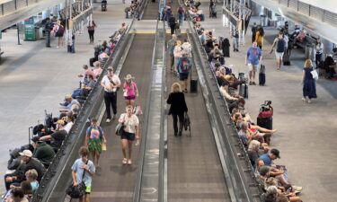 Travelers walk through Denver International Airport in Colorado