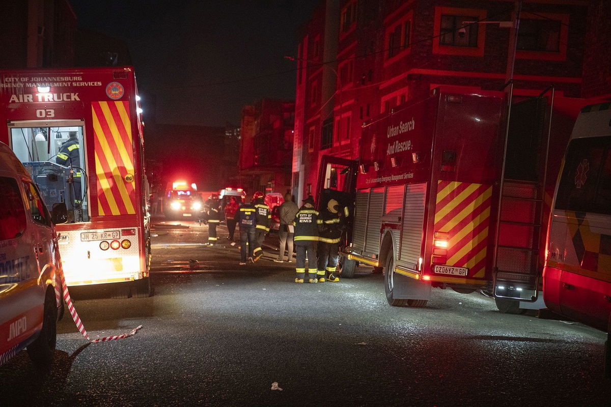 <i>Michele Spatari/AFP/Getty Images</i><br/>Rescue workers covered bodies in blankets and sheets outside the building.